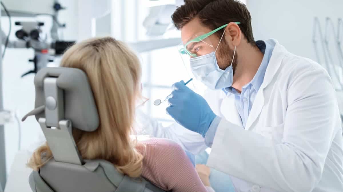 Patient receiving professional teeth whitening with a laser device Blackburn